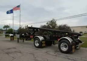 Two-Container-Roll-Off-Trailer-Canadian Canadian Two Container Roll Off Trailer, American flag waving in the background.